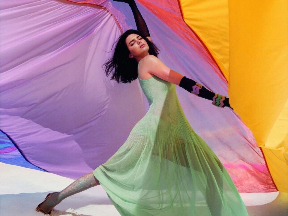 Kendall Jenner holding up a colorful fabric