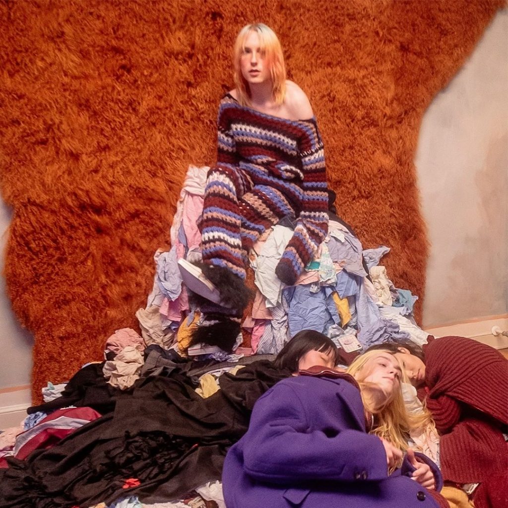 People lying on a pile of excessive inventory